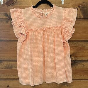 Woman’s peach blouse